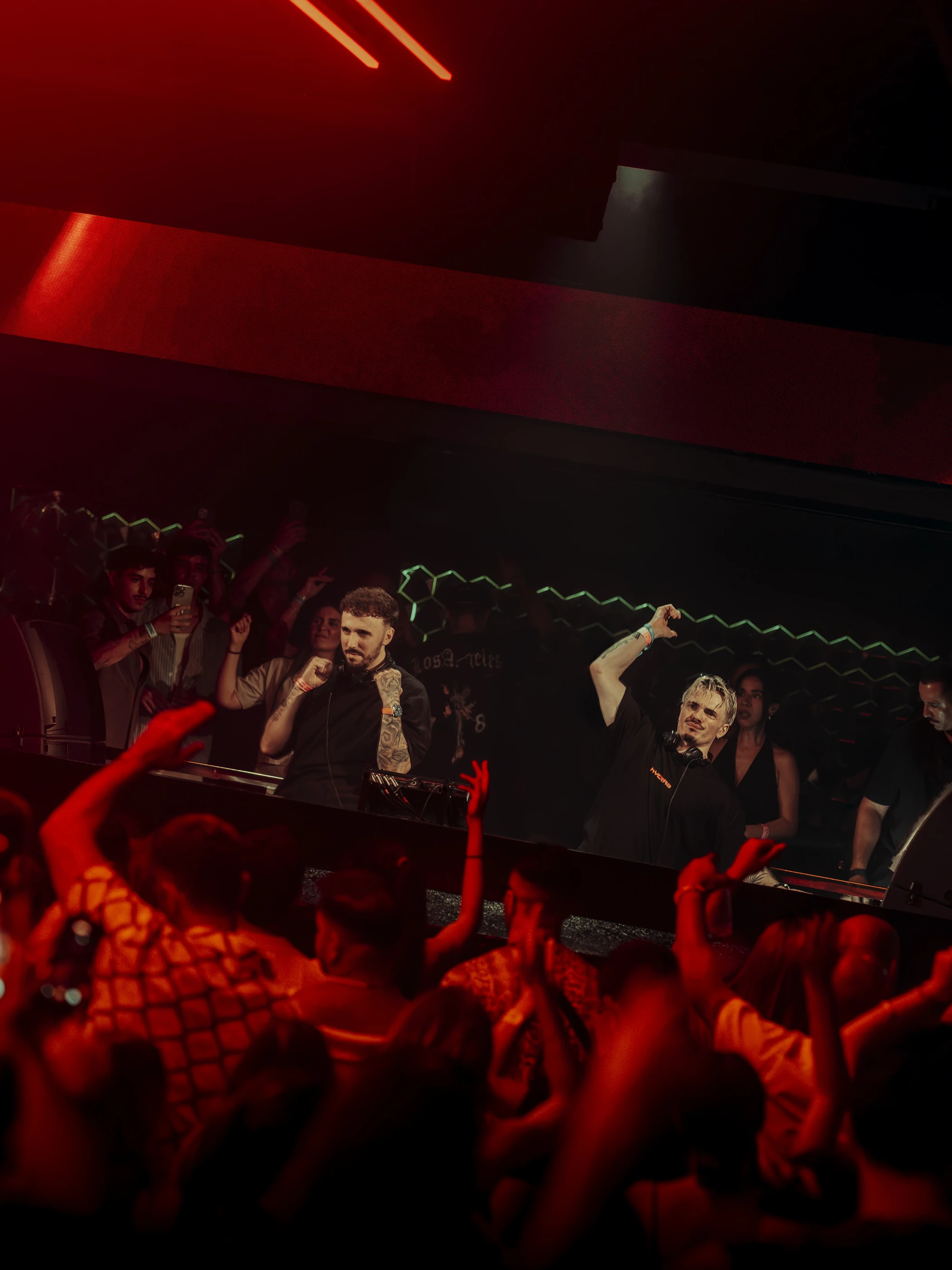 Mia Mendi on stage under red lights at Hï Ibiza